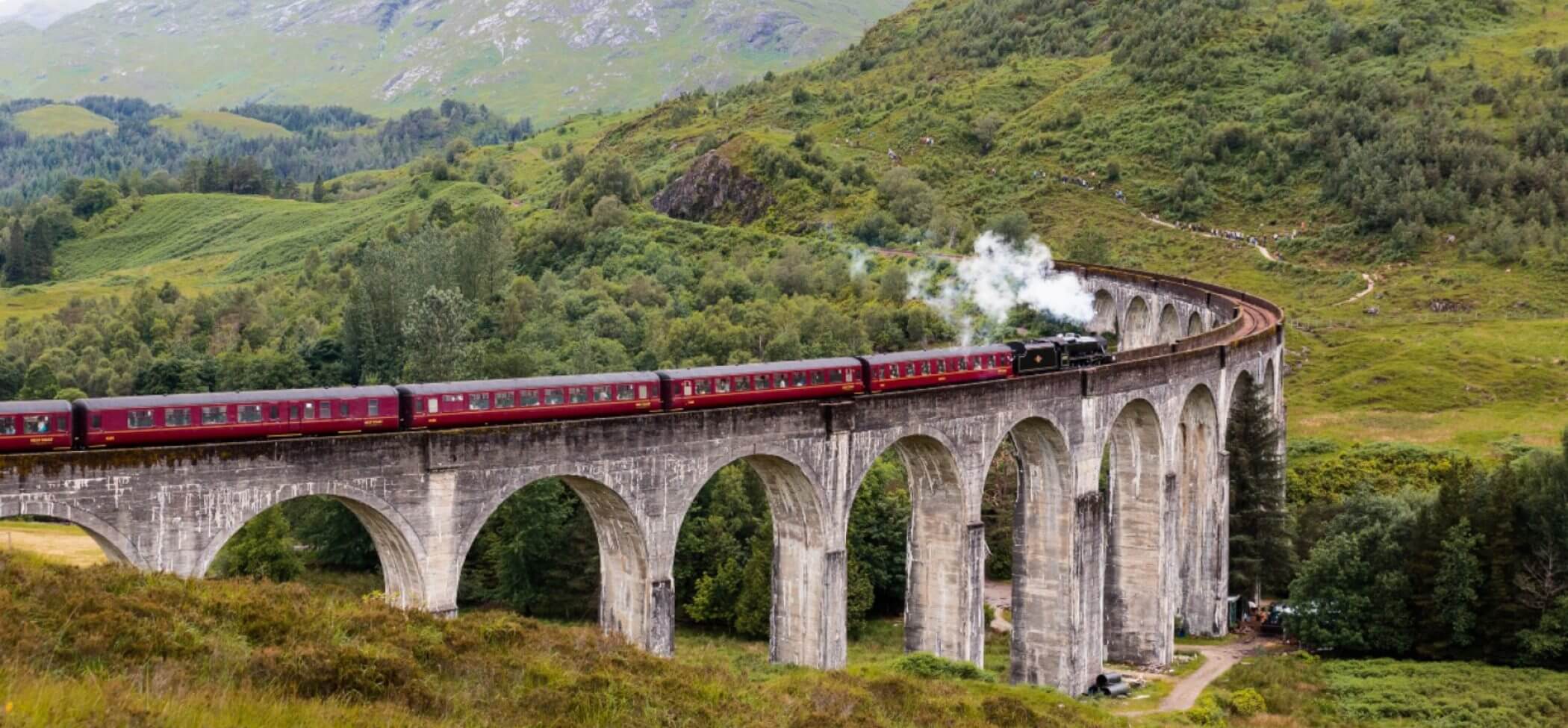 The Hogwarts Express chugs over the Glenfinnan Viaduct in the Scottish Highlands.