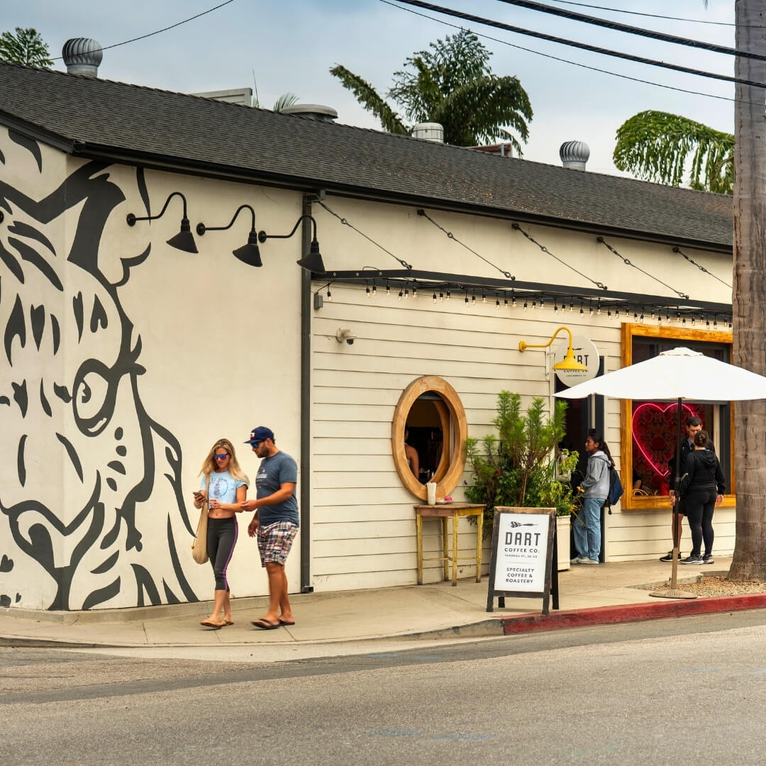 People walk outside Dart Coffee Company in Santa Barbara’s Funk Zone.