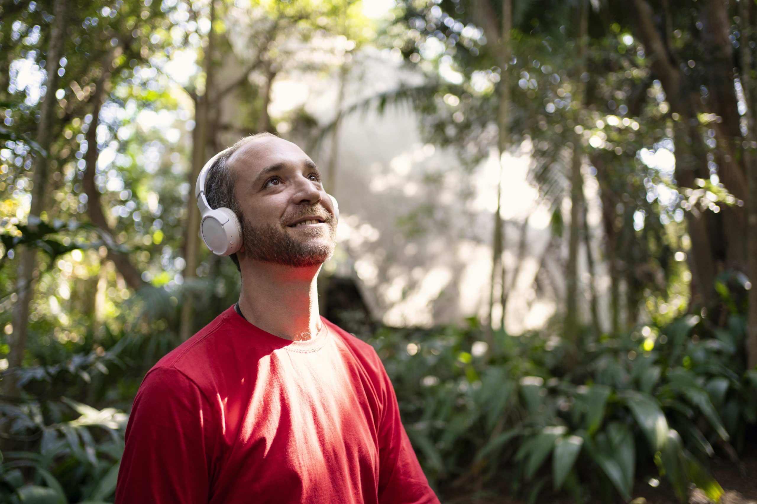 Man wearing noise-canceling headphones to reduce sensory overload.