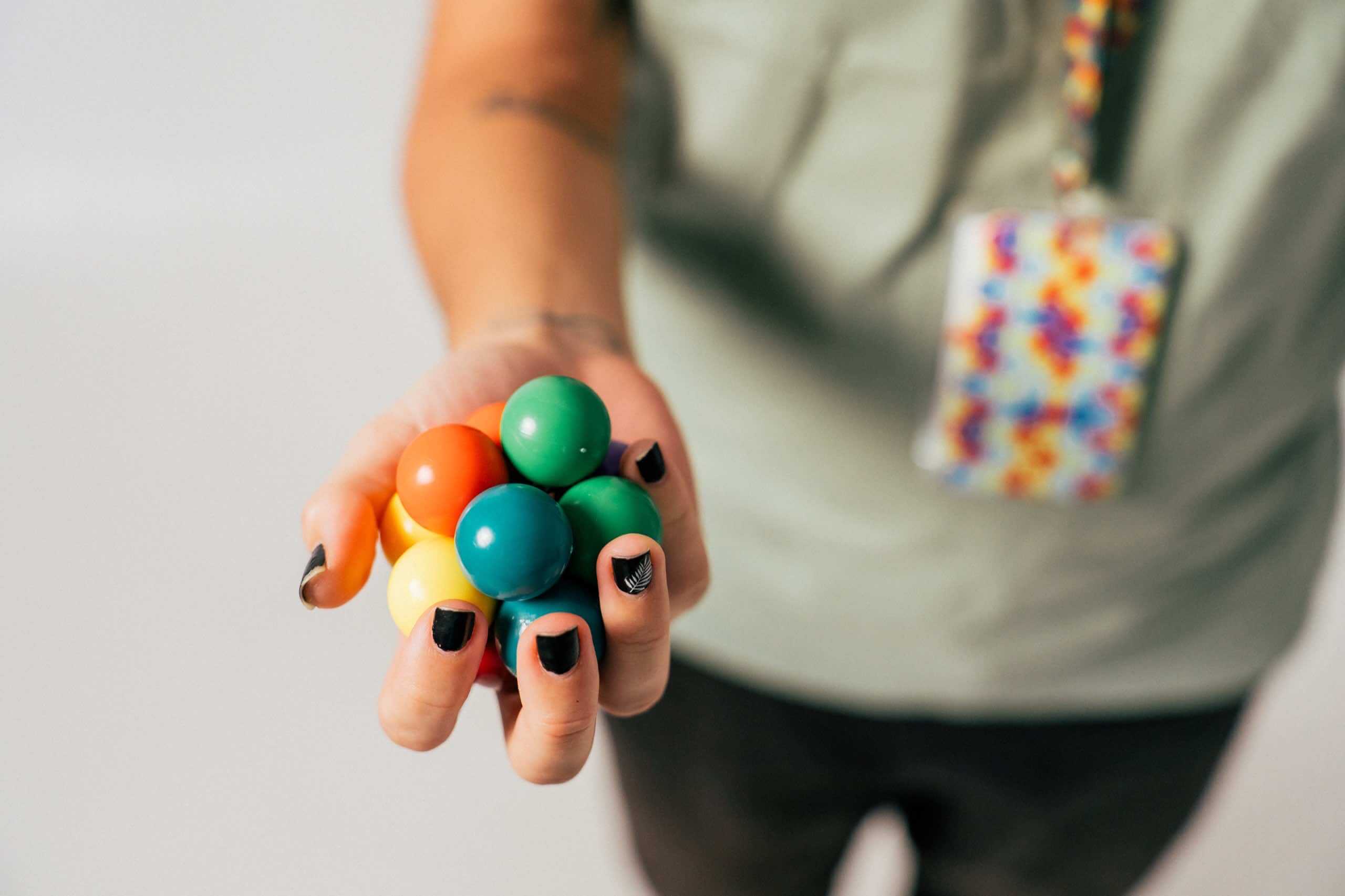 Hand holding colorful fidget toy used to manage sensory input.